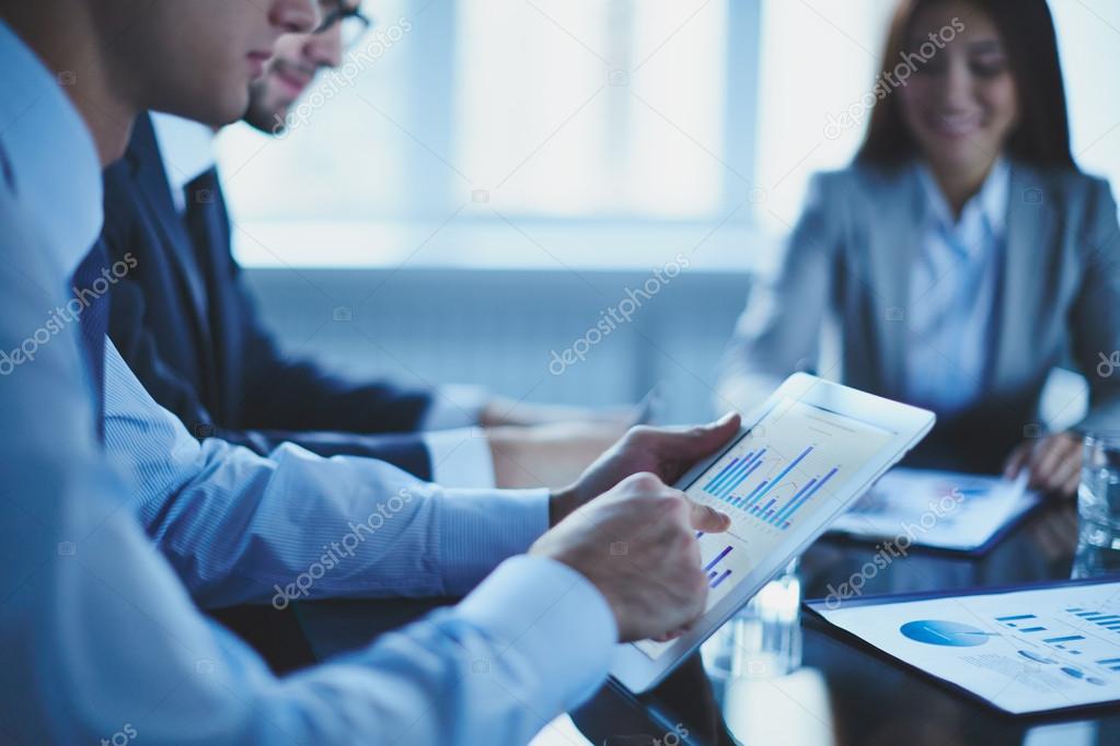 Businessperson pointing at document in touchpad