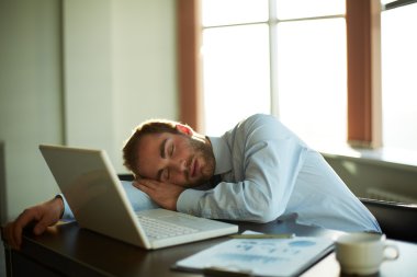Sleeping businessman at work clipart