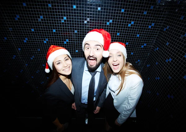 Joyful colleagues in Santa caps — Stock Photo, Image