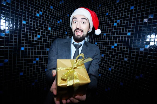 Businessman offering Christmas gift — Stock Photo, Image