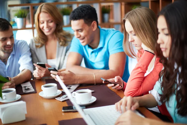 Friends using modern gadgets — Stock Photo, Image