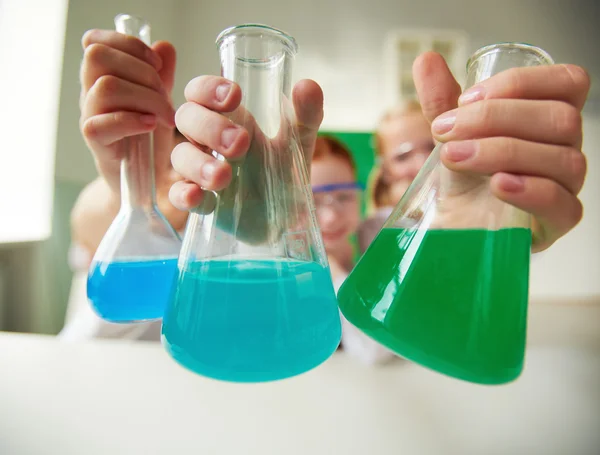 Schoolchildren holding tubes — Stock Photo, Image