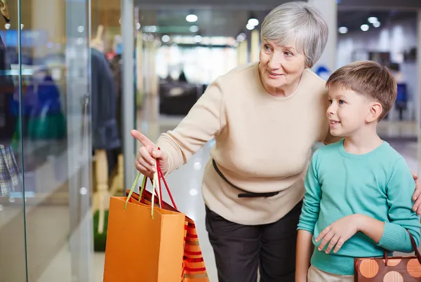 Child and his grandmother with paperbags — Stock Photo, Image