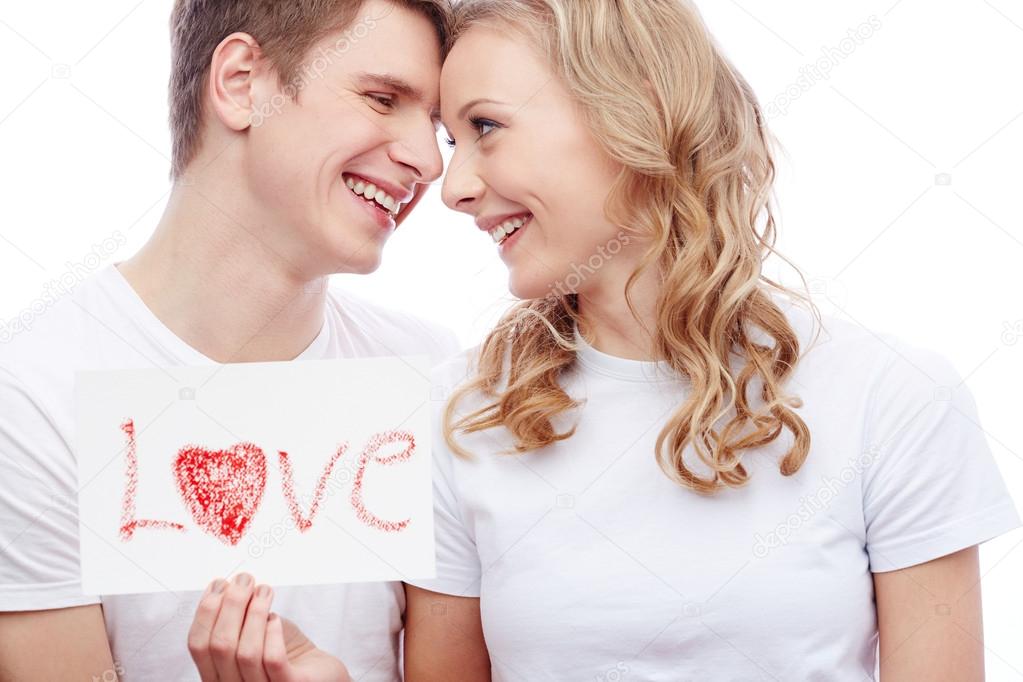 Couple holding paper with word love