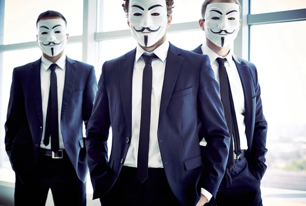 Anonymous men Portrait of three masked guys — Stock Fotó