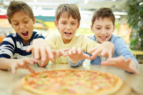 Pojkar äta pizza — Stockfoto