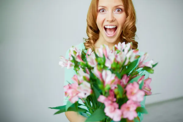 Ecstatic woman with flowers — Stock Photo, Image