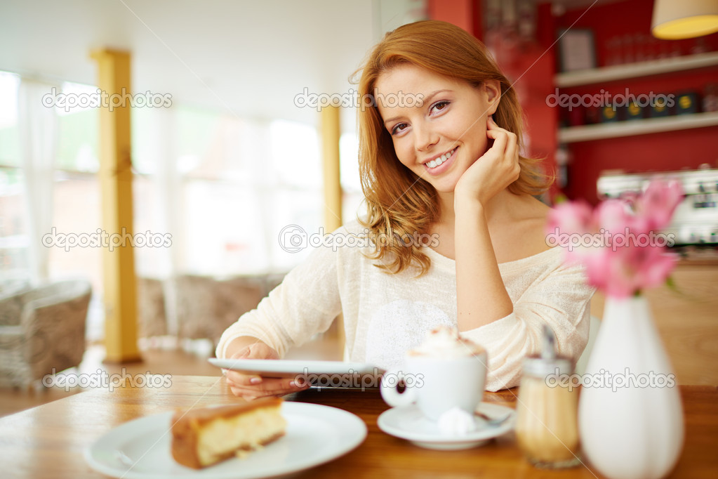 Female with touchpad  in cafe