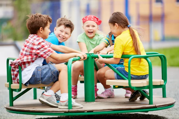 Friends  on carousel — Stock Photo, Image