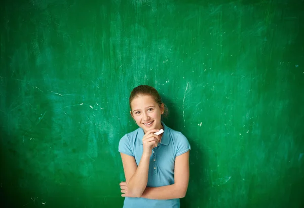 Schoolgirl with piece of chalk — Stock Photo, Image