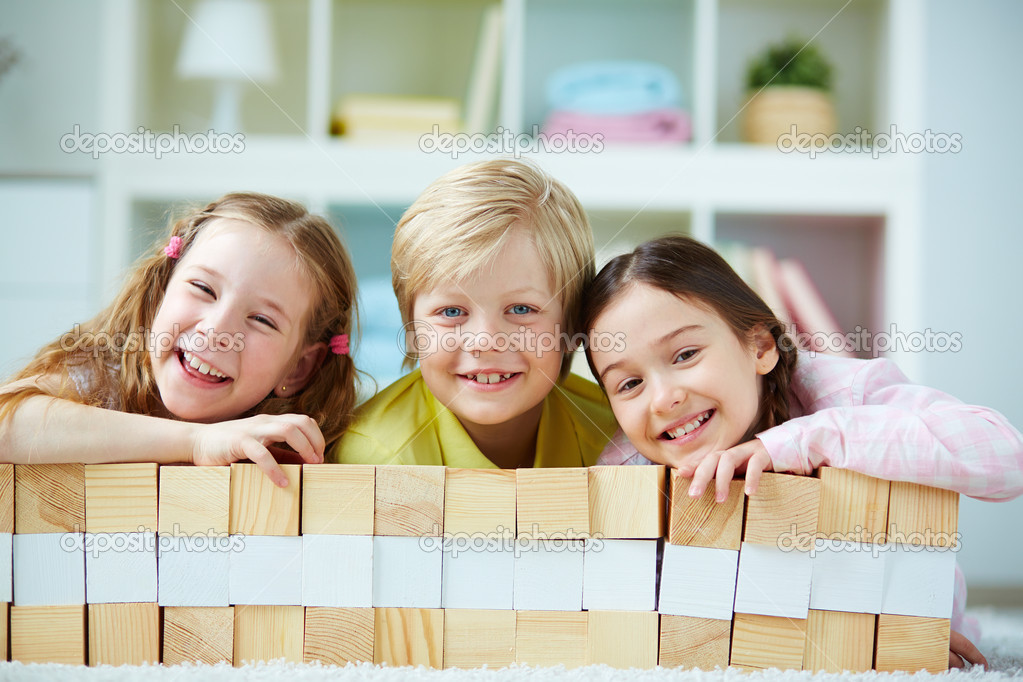 Friends playing with wooden bricks