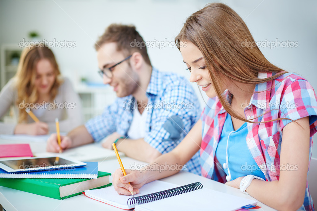 Girl and her groupmates working at lesson