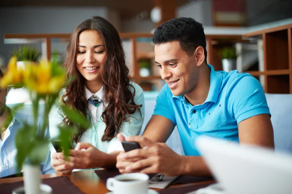 Friends using gadgets in cafe — Stock Photo, Image