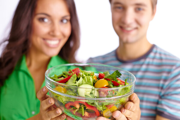 Couple showing vegetable salad