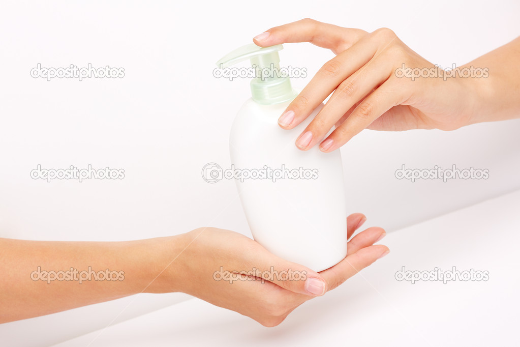 Hands holding lotion