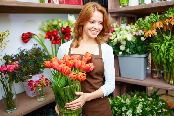 Woman florist with red tulips — Stock Photo, Image