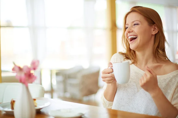 Vrouw met kopje koffie lachen — Stockfoto