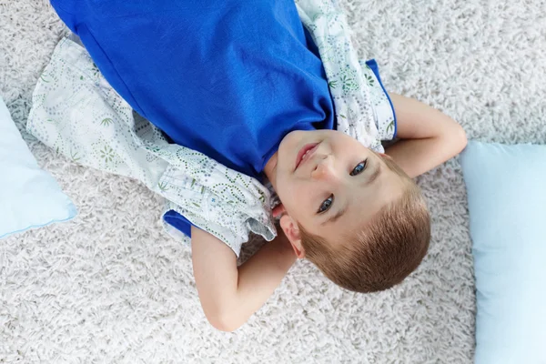 Мальчик лежит на полу — стоковое фото