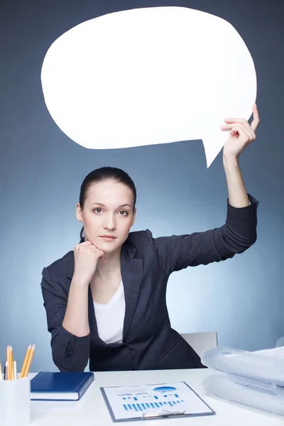 Businesswoman holding blank speech bubble — Stock Photo, Image