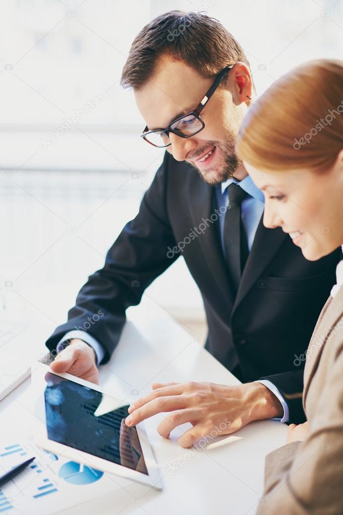 Businessman and colleague using touchpad