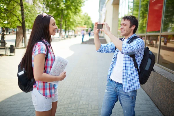 Man taking photo of girlfriend during journey — Stock Photo, Image