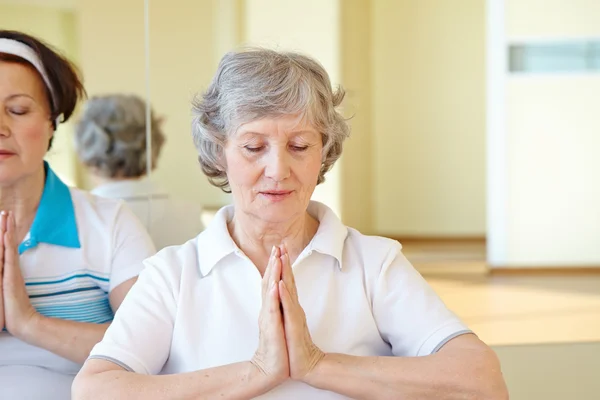 Aged women doing yoga exercise — Stock Photo, Image