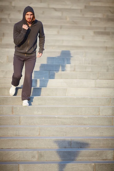 Sportsman running down steps — Stock Photo, Image