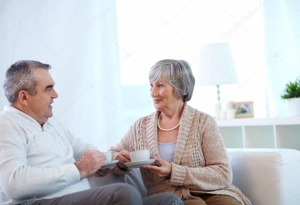 Couple of pensioners drinking tea