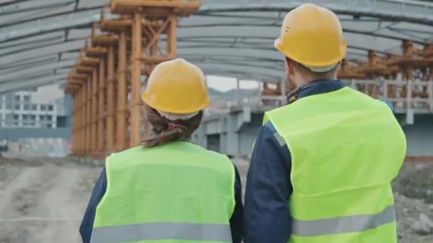 Tracking Rear View Male Female Construction Site Supervisors Safety Vests — Stock Video