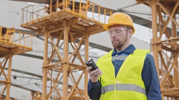 Low Angle Medium Shot Male Engineer Measuring Device Inspecting Construction — Stock Video