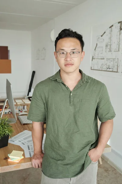 Young professional designer standing against his workplace — Stock Photo, Image