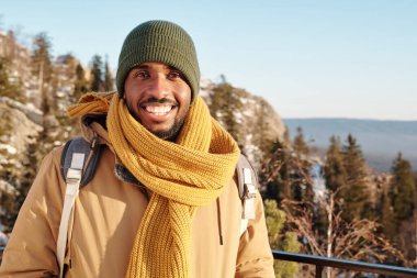 Sırt çantalı genç gezgin kış macerasının tadını çıkarıyor.