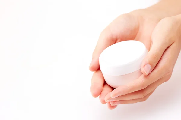 Female manicured hands holding cream — Stock Photo, Image