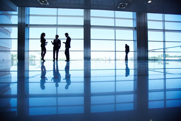 Office workers standing by the window — Stock Photo, Image