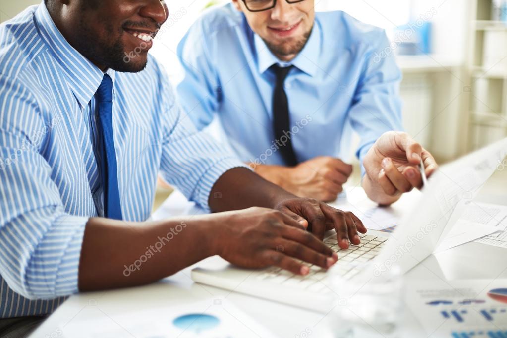 Businessmen discussing computer project