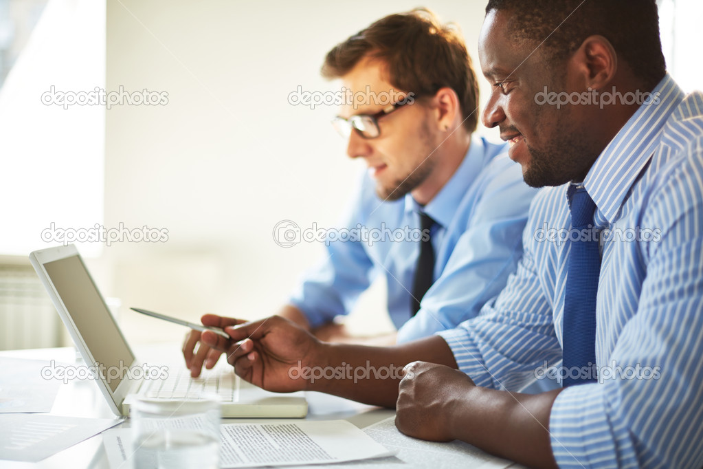 Businessmen using laptop