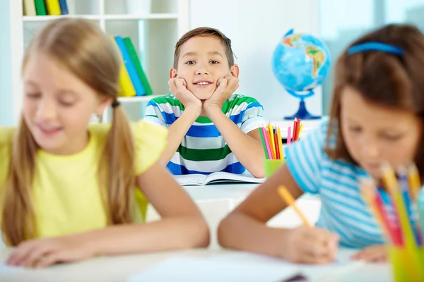 Smart boy between classmates — Stock Photo, Image