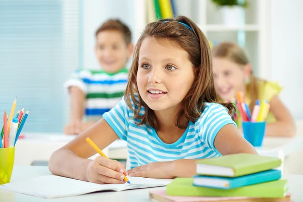 Menina bonito e seus dois colegas de escola na lição — Fotografia de Stock