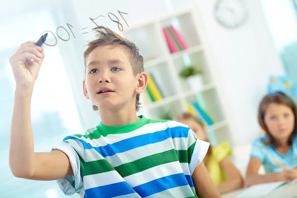 Clever boy doing sums — Stock Photo, Image