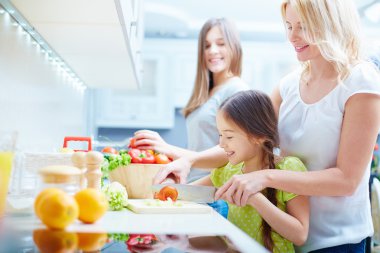 Anne ve iki kızı pişirme