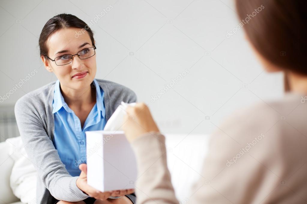 Psychiatrist giving  tissues to patient