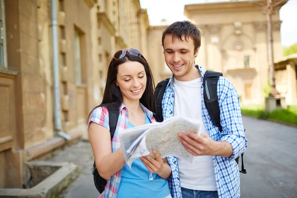 Travelers studying map Stock Image