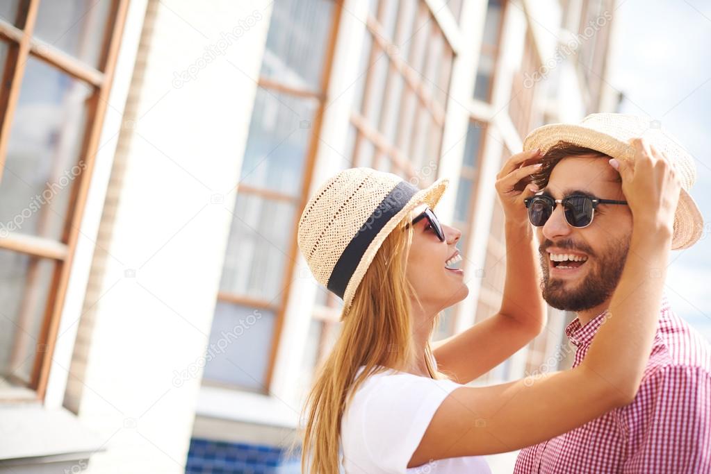 Girl and boyfriend in hats and sunglasses