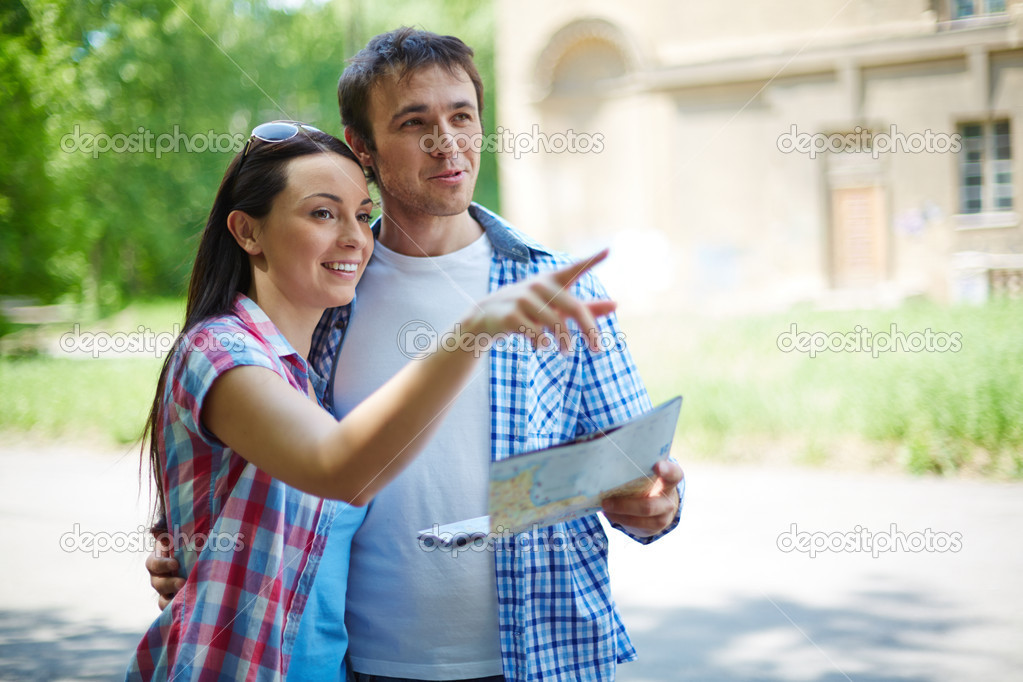 Woman explaining husband sights of city