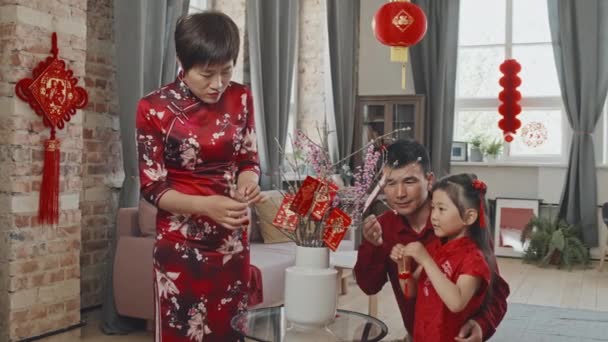 Medium Shot Slowmo Chinese Family Red Traditional Clothing Putting Lunar — Stock Video