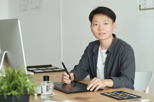 Pretty young Asian designer drawing sketch on computer screen — Stock Photo, Image