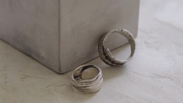 Extreme Close Metal Rings Lying Concrete Block — Stock Video