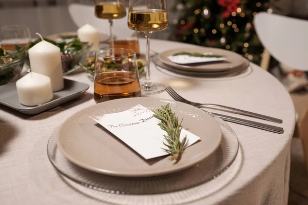 Served festive table with drinks, candles, plates with invitations and food — Stock Photo, Image