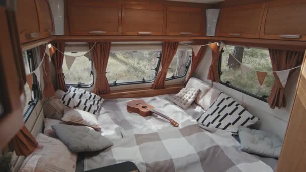 跟踪舒适的露营者内部的慢动作 Ukulele躺在床上 玻璃窗上挂着玻璃幕墙 — 图库视频影像