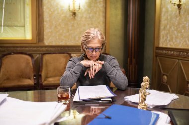 Çağdaş olgun kadın avukat gazete okuyor.